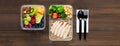 Wholesome nutrient rich food set in take away boxes with spoon and fork on wood table banner background