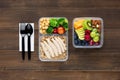 Wholesome nutrient rich food set in take away boxes with spoon and fork on wood table ready to eat Royalty Free Stock Photo