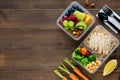 Wholesome nutrient rich food set in take away boxes on wood table background with copy space Royalty Free Stock Photo