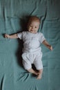 Top view wide angle newborn baby lies in a crib arms. A newborn baby is resting in bed. Nursery for small children. Family morning Royalty Free Stock Photo