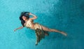 Top view wide banner to beautiful young sexy brunette woman in golden dress, evening dress, swimming weightless elegant in the