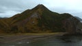 Top view of wild coast with rocky mountains. Clip. Flock of seagulls on ocean shore on backdrop of amazing mountains Royalty Free Stock Photo