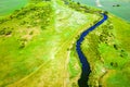Top view of winding river and summer fields with bushes Royalty Free Stock Photo
