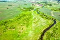 Top view of the winding river and summer fields with bushes Royalty Free Stock Photo