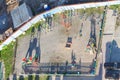 Top view from the window of an apartment building on a childrens playground of multi-colored carousels fenced with a concrete Royalty Free Stock Photo