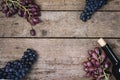 Top view Wine Background Wine Bottles Black and Pink Ripe Grapes on Wooden Background Horizontal Copy Space Frame Royalty Free Stock Photo