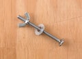 Wing nut and threaded bolt with washer on plywood Royalty Free Stock Photo