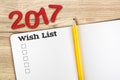 Top view of 2017 wish list red number with blank open notebook a Royalty Free Stock Photo