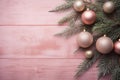 Top view of a witner tree branches and pastel pink glass ball on a textured blush pink wooden background. Christmas copyspace in Royalty Free Stock Photo