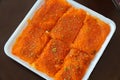 Top view wof Knafeh traditional Middle Eastern dessert food on disposable dish