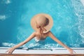 Top view of Woman in beach hat enjoying in swimming pool on luxury tropical resort. Exotic Paradise. Travel, Tourism and Vacation