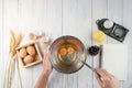 Top view of woman chef breaking an egg into the bowl. Female ch Royalty Free Stock Photo