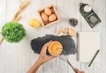 Top view of woman chef breaking an egg into the wood bowl. Female chef whisking eggs in wood bowl on white table Royalty Free Stock Photo