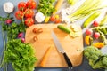 Top view of woman cooking healthy food: cutting vegetable ingredients Royalty Free Stock Photo