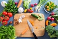 Top view of woman cooking healthy food: cutting vegetable ingredients Royalty Free Stock Photo