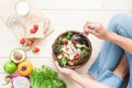 Top view woman eating chicken salad with fruits, vegetables, who