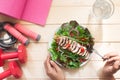 Top view of woman eating healthy salad with fitness equipments