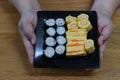 Top view, woman hand holding a dish, set meal, Japanese food, sushi, sweet egg, shrimp egg, takoyaki rice ball Royalty Free Stock Photo