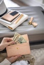 Top view woman hands counting checking cash money dollars and documents before leaving to vacation