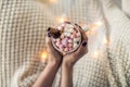 Top view of woman hands with cup of hot chocolate and marshmallows Royalty Free Stock Photo