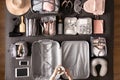 Top view woman hands getting ready to travel vacation packing suitcase use konmari method Royalty Free Stock Photo