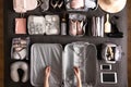 Top view woman hands getting ready to travel vacation packing suitcase use konmari method Royalty Free Stock Photo