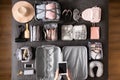 Top view woman hands getting ready to travel vacation packing suitcase use konmari method Royalty Free Stock Photo