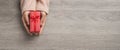 Top view of Woman hands is holding a small red gift box Royalty Free Stock Photo