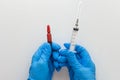 Top view of woman hands in medical gloves holding two ml ampoule with vitamin group B for injection and five ml syringe