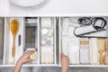 Top view of woman hands neatly organizing bathroom amenities and toiletries in drawer in bathroom. Royalty Free Stock Photo