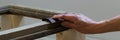 Top view of woman hands sawing a wooden plank indoors. Concepts - craft, carpentery, DIY