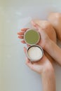 Top view of woman hands with solid soap on white water background, taking bath Royalty Free Stock Photo