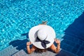 Top view of a woman with hat sunhat sitting in a swimming pool Royalty Free Stock Photo