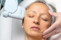 Top view of middle aged woman having facial hifu energy treatment