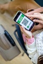 Top view woman holding identification documents vaccine certificate on smartphone screen at airport Royalty Free Stock Photo