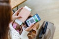 Top view woman holding identification documents vaccine certificate on smartphone screen at airport Royalty Free Stock Photo