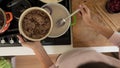 Top view of woman making chocolate sauce for sweet desert