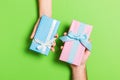 Top view of a woman and a man exchanging gifts on colorful background. Couple give presents to each other. Close up of making Royalty Free Stock Photo