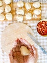 Top view of woman preparing handmade lunch like bread or pizza in traditional work at home on table in the kitchen. Unrecognizable Royalty Free Stock Photo