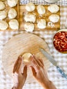 Top view of woman preparing handmade lunch like bread or pizza in traditional work at home on table in the kitchen. Unrecognizable Royalty Free Stock Photo