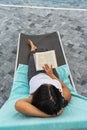 High angle view of woman reading book on summer vacation Royalty Free Stock Photo