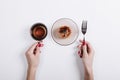 Top view of a woman's hands holding a cup of tea and fork, on th Royalty Free Stock Photo