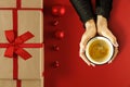 Top view of woman`s hands holding hot drink. Free space for decorations on christmas background. Cup of hot chocolate or coffee. Royalty Free Stock Photo