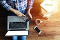 Top view of woman shopping online via laptop computer ,using calculator for calculate value price on wooden floor Royalty Free Stock Photo