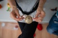 Tying golden string to a shiny christmas bauble