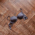 Woman bra thrown on wooden floor Royalty Free Stock Photo