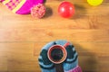 Top view women`s hands, gloves, Silk hat, colored balls and a cup of coffee on wood table. Royalty Free Stock Photo