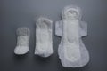 Top view of women sanitary pad in various size isolated on grey background