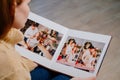 woman watches photobook from photo shoot of married couple during pregnancy.