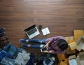 Top view of women working smart phone from home on wooden floor with postal parcel,